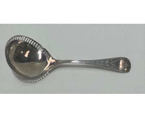An Edwardian Britannia standard silver caddy spoon, the handle with bright cut decoration, the bowl with pierced rim, maker L