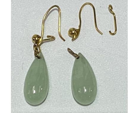A pair of gold mounted green jade drop earrings, length of jade 18mm, weight 4.4g approx.