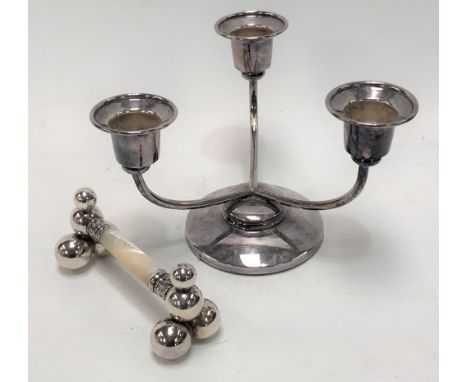 Silver plated three branch squat candelabra, height 9cm; together with a silver plated mother of pearl knife rest (2)