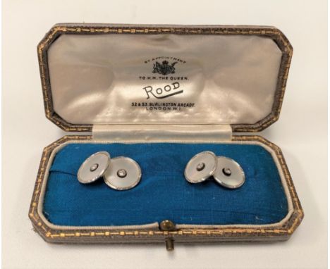 A good pair of platinum and 18ct white gold diamond set mother of pearl and onyx cufflinks, each diamond of 0.05ct spread app