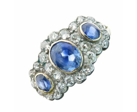 Sapphire and diamond triple cluster ring, stamped 18ct, the graduated oval cuts enclosed by twenty-six old single cuts, size 