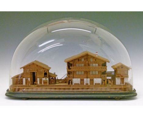Finely constructed 19th Century Swiss pearwood model of a chalet with outhouses, 56cm wide, displayed beneath a glass dome  C