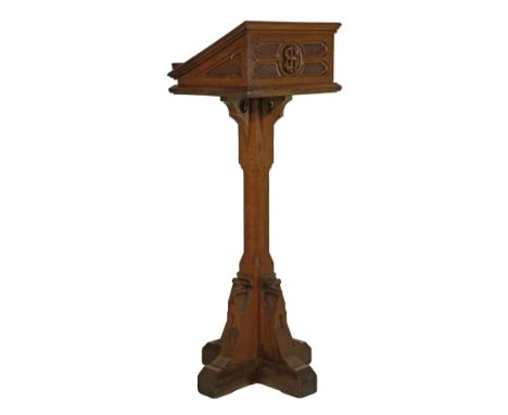 Late 19th/early 20th Century light oak Gothic style lectern having carved decoration and standing on a chamfered pillar and q