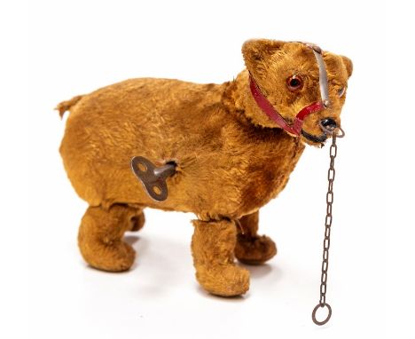 Schuco: An early 20th Century Schuco mohair clockwork bear with muzzle, 16cm approx.