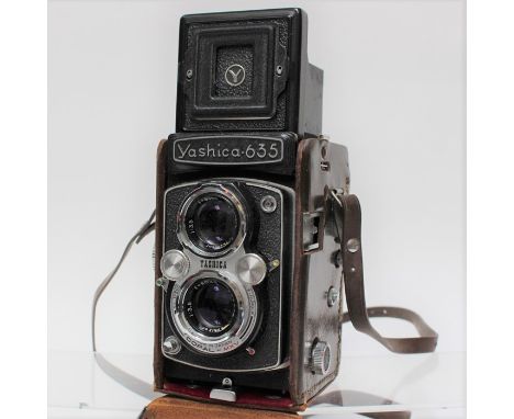 Yashica: A cased Yashica 635 TLR camera, complete with a Yashicamat manual, a lens hood and filter.