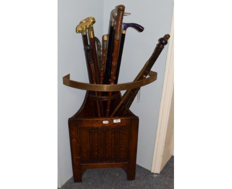 A linen-fold carved corner stick-stand, together with nine various walking sticks and other items 