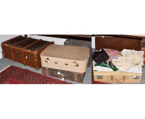 Early 20th century embroidered shawls, lace, fans, etc, contained in a suitcase, together with two further suitcases, a woode