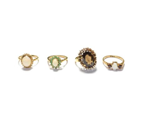 A 9 carat gold opal ring, finger size M1/2; a 9 carat gold opal and emerald cluster ring, finger size K1/2; a smokey quartz r