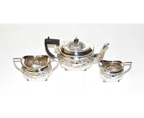 A silver three-piece tea service, Birmingham marks, with ornate repousse decoration of scrolls and leaves, 18.54ozt gross 
