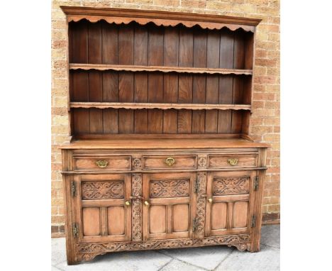 20TH CENTURY LIGHT OAK DRESSER, the upper section with a moulded cornice, above a two tier open plate rack, above a base of t