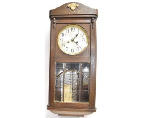 AN OAK CASED WALL CLOCK  the spring driven movement striking on four rods, with leaded and bevel glazed door, Condition Repor