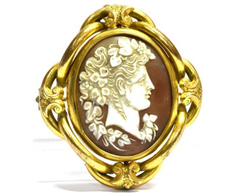 A VICTORIAN LARGE YELLOW METAL SWIVEL BROOCH the central oval swivel comprising a shell cameo portrait to one side and pictur