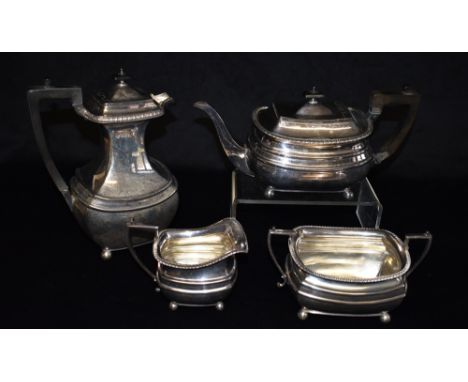 A SILVER FOUR PIECE TEA SET Comprising teapot, large lidded water jug, sugar bowl and milk jug of plain cushion shape on 4 ba