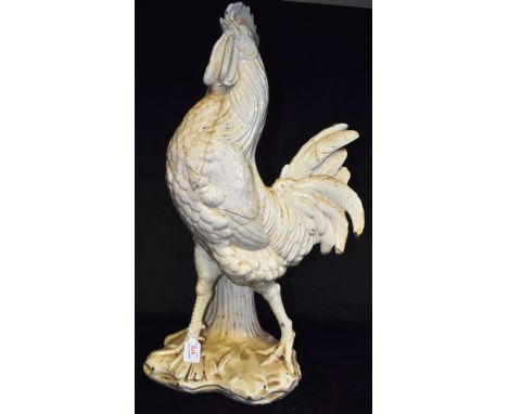 A VERY LARGE CERAMIC FIGURAL STICKSTAND naturalistically modelled as a cockerel standing by a sheath of corn, 71cm high Condi