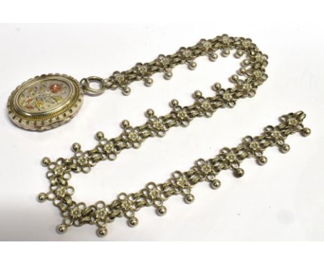 A VICTORIAN SILVER LOCKET  with inlaid yellow and rose gold floral decoration to front, 45mm long together with a fancy link 