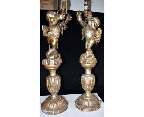 A LARGE PAIR OF CARVED AND GILDED FIGURAL LAMP BASES  modelled as cherubs, approx 89cm high overall Condition Report : old da