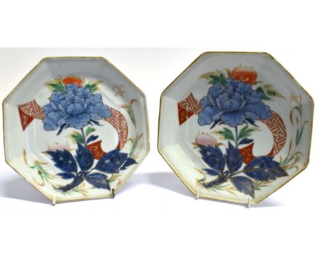 A PAIR OF CHINESE PORCELAIN PLATES of octagonal form, enamelled floral decoration heightened in gilt, 21cm diameter, bearing 