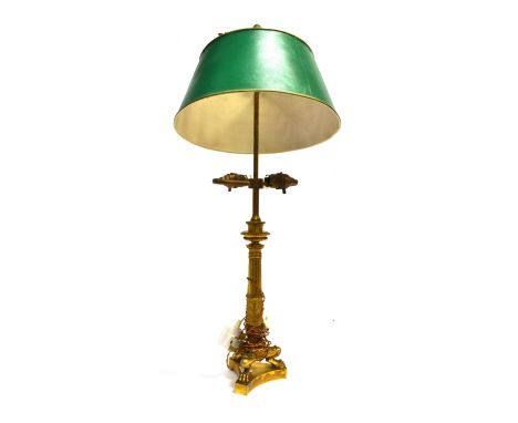A PATINATED BRASS TABLE LAMP  the sliding shade with an arrow-flight adjuster, the Corinthian column with cast acanthus decor