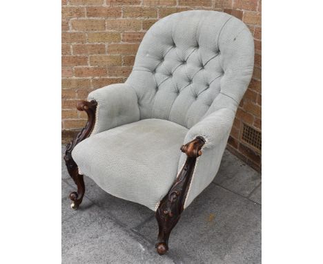 A VICTORIAN UPHOLSTERED BUTTON BACK ARMCHAIR  in herringbone grey fabric, the cabriole front supports with carved scrollwork 