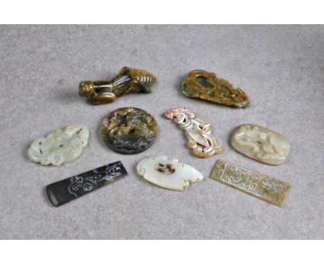 Nine Chinese jade carvings, all probably 20th century, including a praying mantis, a disc carved with three chilong, a smalle