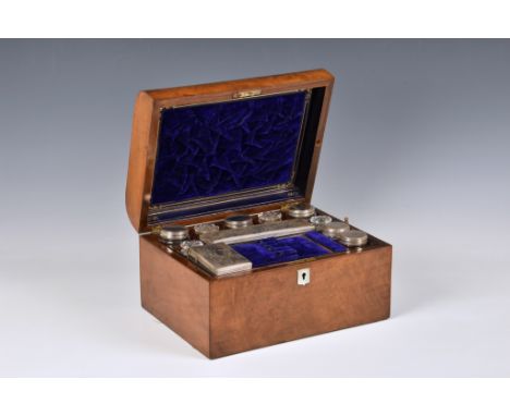 A Victorian walnut toilet box, of casket form with mother of pearl shield shaped escutcheons, opening to reveal fitted interi