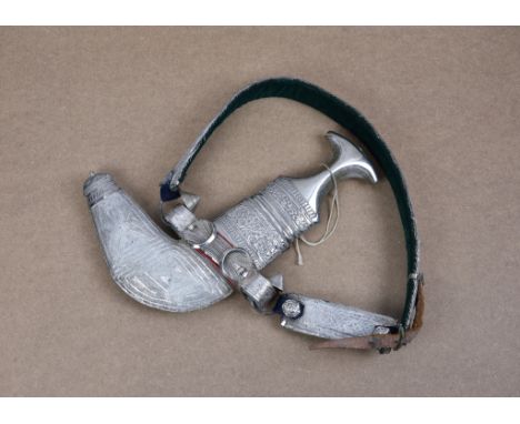 An early 20th century Omani Khanjar dagger and belt, steel blade (showing rust), waisted horn hilt with silver mounts, decora