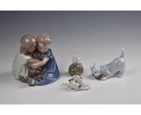 A Royal Copenhagen porcelain figure group, depicting a pair of seated children cuddling a puppy, No. 707, printed and painted