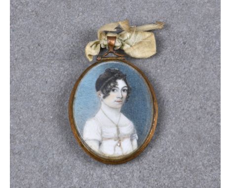 An early 19th century miniature portrait of a young woman, housed in locket, the pretty young woman wearing white dress, and 