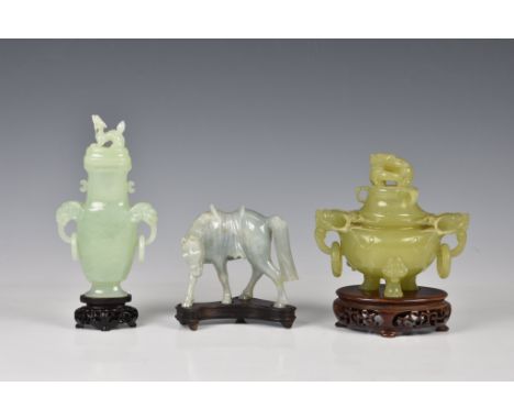 Three Chinese jade style hardstone carvings, 20th century, comprising a covered tripod censer, in pale green hardstone, of be