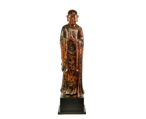 A lacquered and gilt carved wooden figure of a standing monk or Lohan, probably Burmese, Mandalay period, late 19th century, 