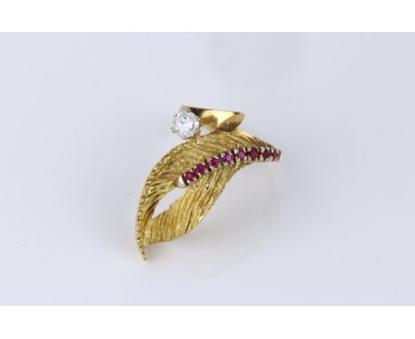 A vintage 18ct yellow gold, ruby and diamond cocktail ring, 1960s-70s, of foliate design, set with a row of round cut rubies 