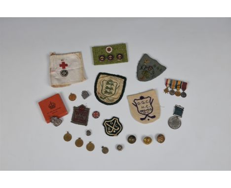 Guernsey and Military interest - A collection of patches and medals etc, to include a St John Ambulance / Red Cross arm band;