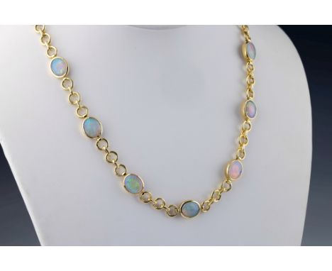 An 18ct yellow gold and opal necklace, the cable chain set with thirteen oval cabochon opals in closed back rub over settings