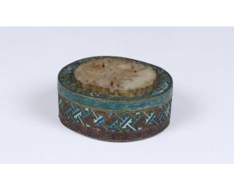 A Chinese champleve enamel and gilt metal oval box, probably 19th / early 20th century, the lid with a pierced mutton fat jad