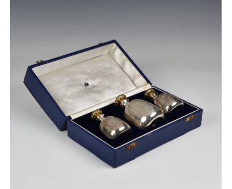 A cased set of three Elizabeth II Silver Jubilee scent / perfume bottles by Asprey, London, 1977, each of mallett form with s