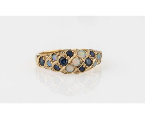 A 14ct yellow gold, opal and sapphire ring, the bright cut, domed shank diagonally set with alternate rows of round cut sapph