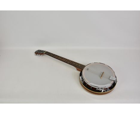 A Martin Smith six string contemporary banjo, with 11in. Remo skin, spare strings and contact pick-up, in original soft case.
