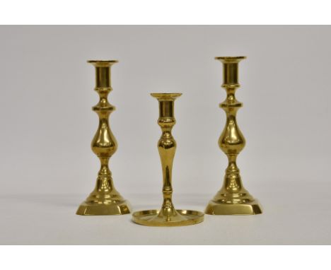 A pair of Victorian brass candlesticks, on knopped baluster stems and clipped square step bases 10in. (25.3cm.) high; togethe