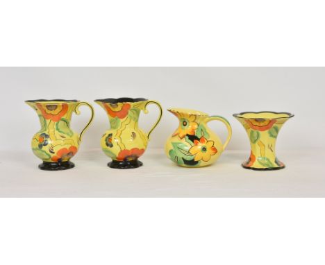 A pair of Wade Heath 1930’s sunflower pattern hand painted jugs, 7 ¾ in. (19.7cm.) high, with matching flared rim vase, 6in. 