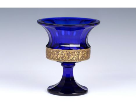 A Moser cobalt blue glass urn with flared rim, acid cut neo classical gilt freeze encircling the base of the bowl, faceted si