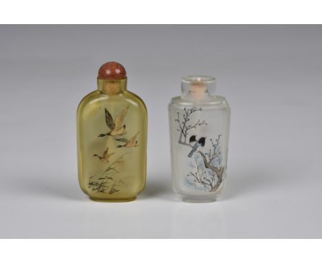 Two Chinese inside painted glass snuff bottles, 20th century, one in pale amber glass, painted with ducks in flight to one si