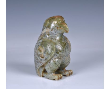 A large Chinese carved celadon green jade figure of a mythical bird, in the archaic style, 20th century, the celadon jade wit