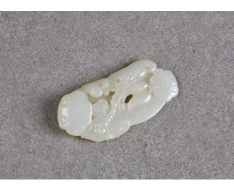 A Chinese very pale celadon jade carving, probably Qing Dynasty, finely carved with a dragonfly, bat and ruyi fungi, 6.7cm. l