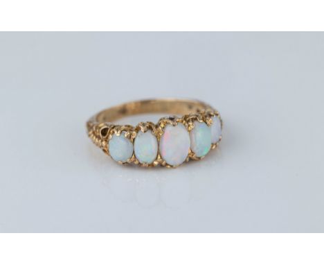 A 9ct gold and opal five stone ring, in the Victorian style, hallmarked London 1972, with five graduated oval cabochon opals,