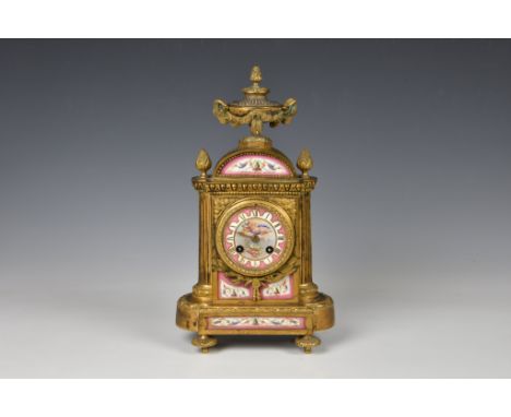 A 19th century French ormolu half hour striking mantel clock, the case with a urn finial with removable cover, with ram's mas