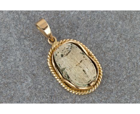 An 18ct gold and Egyptian scarab pendant, the grey stone scarab with traces of green enamel and carved with a hieroglyph of a