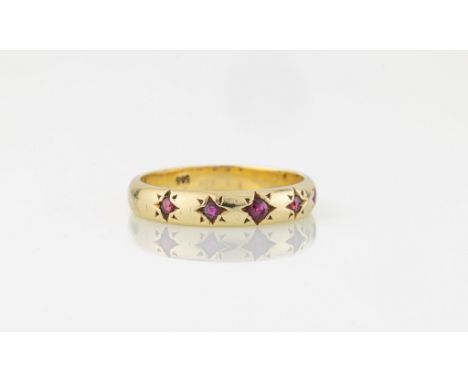 A 14ct yellow gold and ruby five stone ring, the shank star set with five round cut rubies, size P.. 
