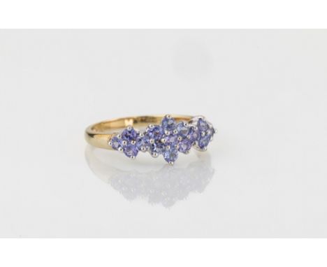 A 9ct yellow gold and Tanzanite ring, with a triple floral cluster with thirteen round cut Tanzanites, size R½.. 