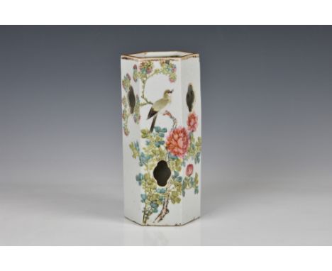 A Chinese porcelain famille rose hat stand, early 20th century, of reticulated, hexagonal form, painted with a bird perched o