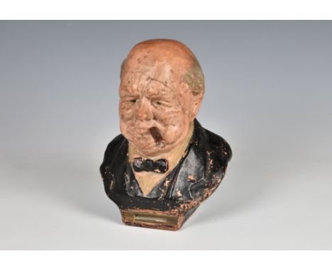 A mid 20th Century terracotta striker / table lighter in the form of Winston Churchill, with his cigar detaching and forming 